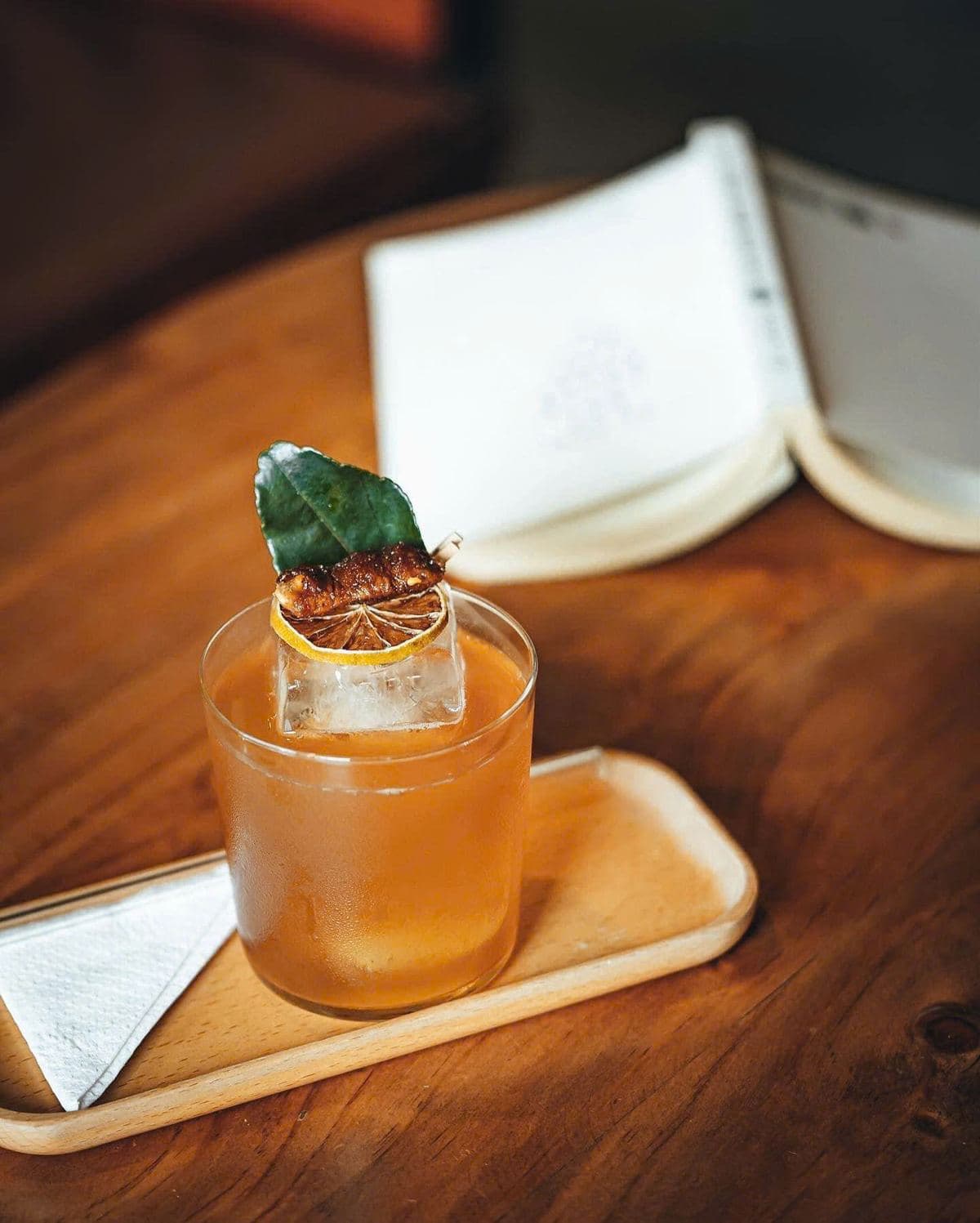 A craft coffee drink served on a wooden tray
