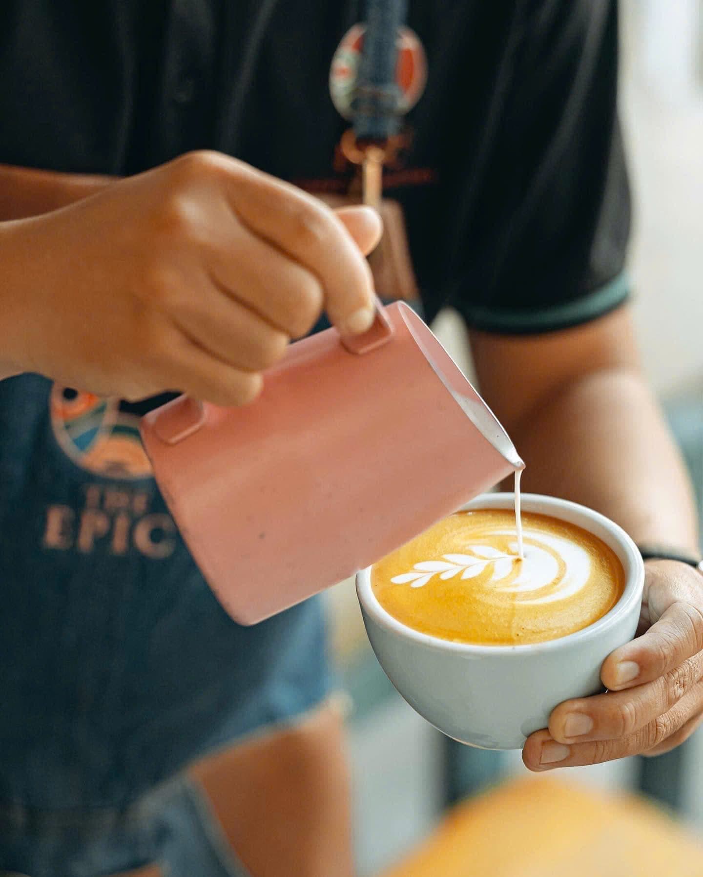 Barista pouring latte art